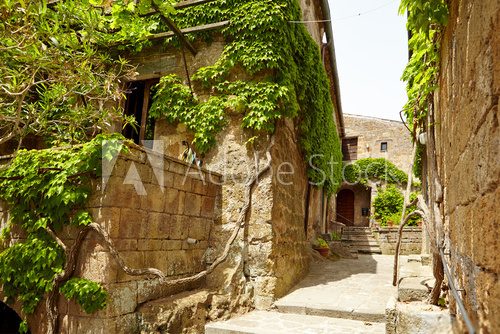 Fototapeta Stara mała kamienna średniowieczna ulica w dziejowym miasteczku, Włochy