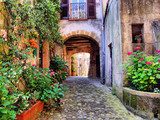 Fototapeta Łukowata brukowiec ulica w Tuscan wiosce, Włochy