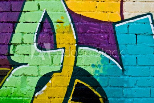 Fototapeta Graffity: Kolorowy szczegół na teksturowanej ścianie z cegły