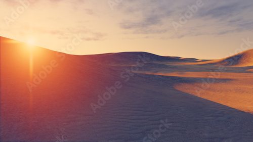 Fototapeta Słońce zachodzi za pustynnymi wydmami