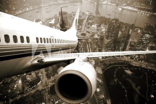 Obraz Lot w przestworza – samolot nad miastem